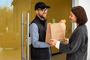Courier delivering a package to a house
